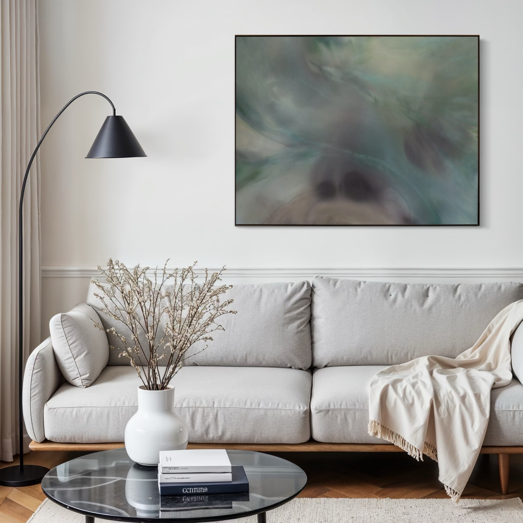 Modern living room with a white sofa, abstract painting, and decorative items.
