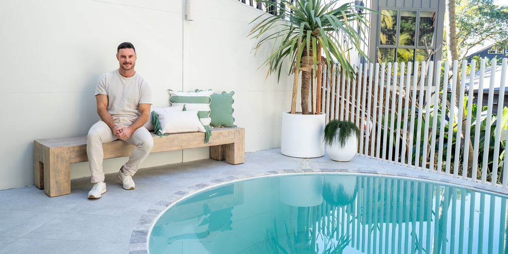 Darren Palmer Sitting on Few & Far’s Odin Coffee Table - Modern Design and Styling