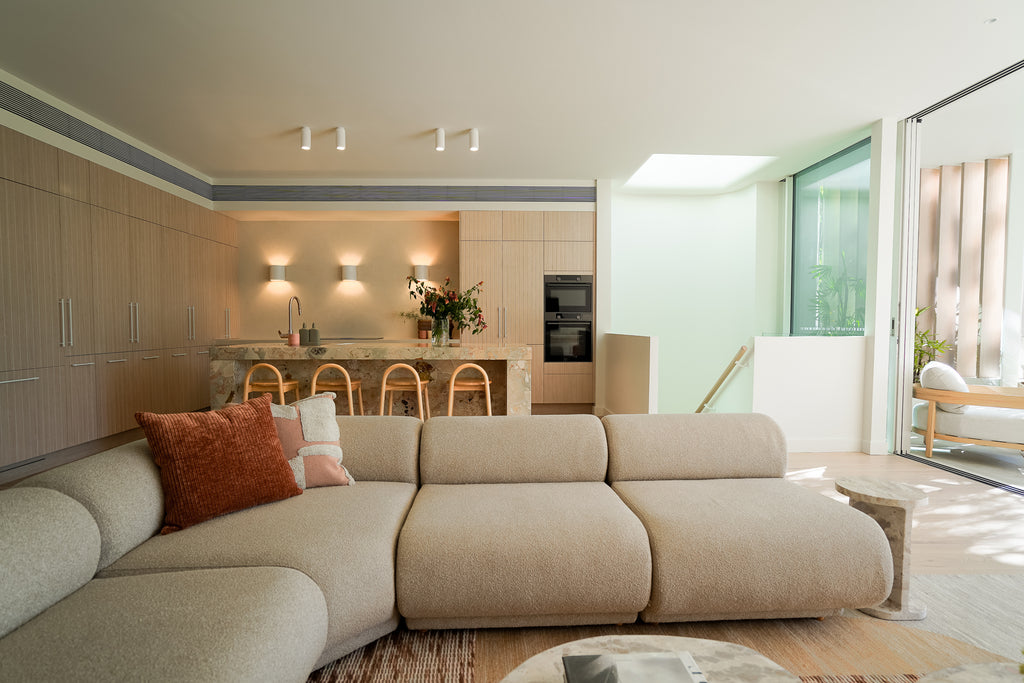 Main Living Area in Darren Palmer’s Bondi Coastal Retreat - Featuring Roland Modular Sofa in Beige, Noah Cushion in Burro, and Capri Round Side Table