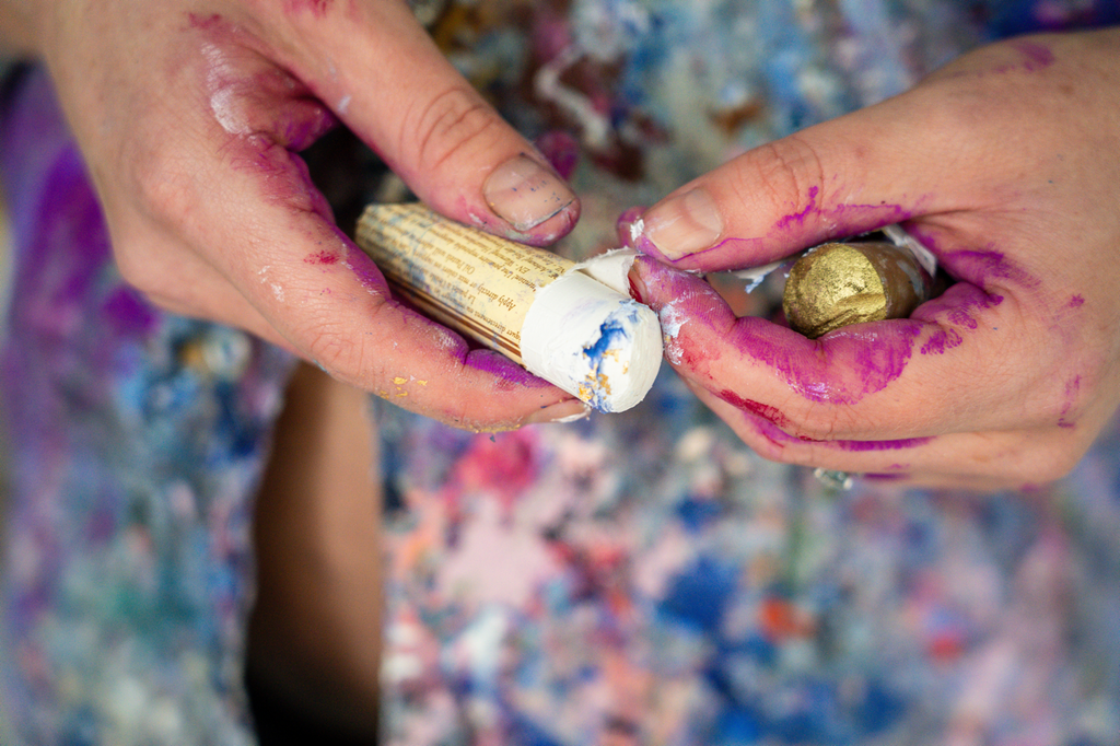 Victoria Wilson preparing oil pastels for a new large floral abstract artwork, carefully selecting colours for her creative process.