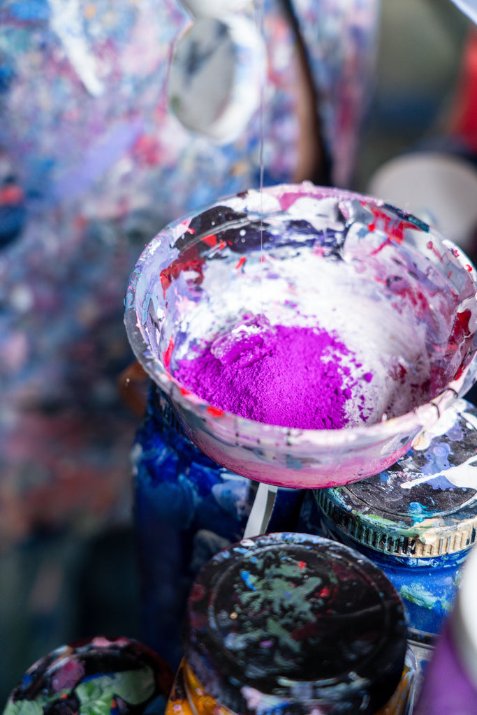 Bright powder pigments being transformed into vibrant paint by Victoria Wilson, showcasing her unique painting mediums and artistic process.