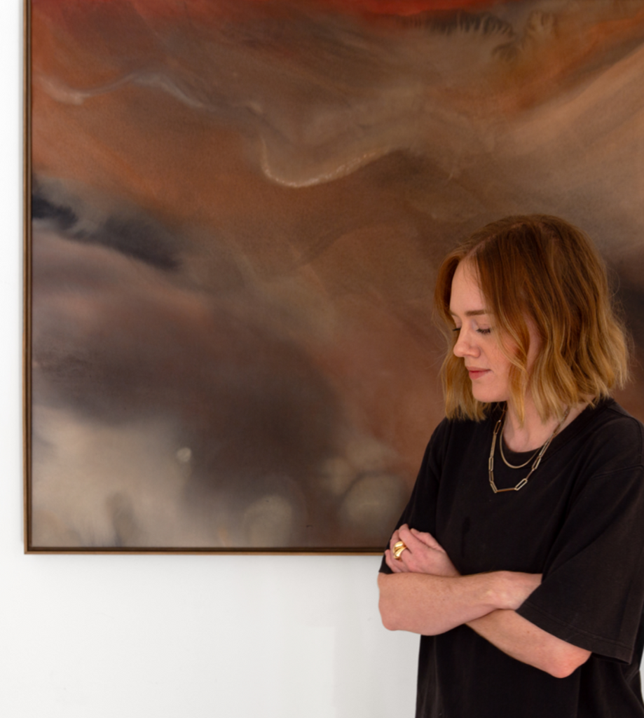 Woman standing in front of a large abstract painting