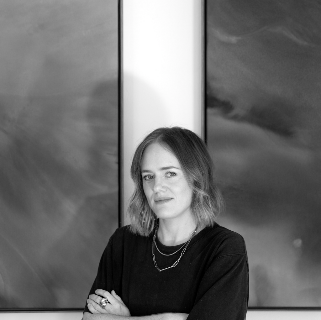 Black and white portrait of a woman with abstract art in the background