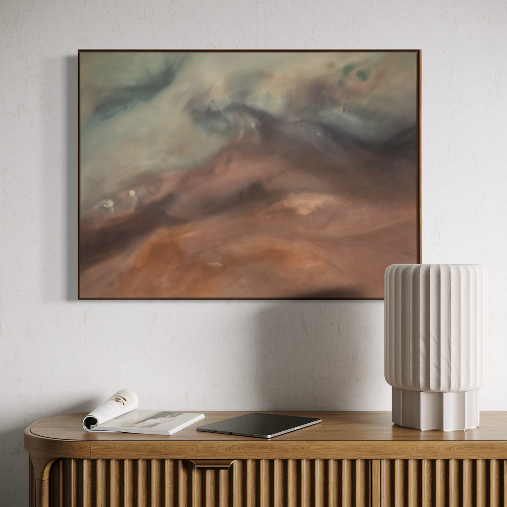 Abstract painting on a wall above a wooden console table with decorative items.
