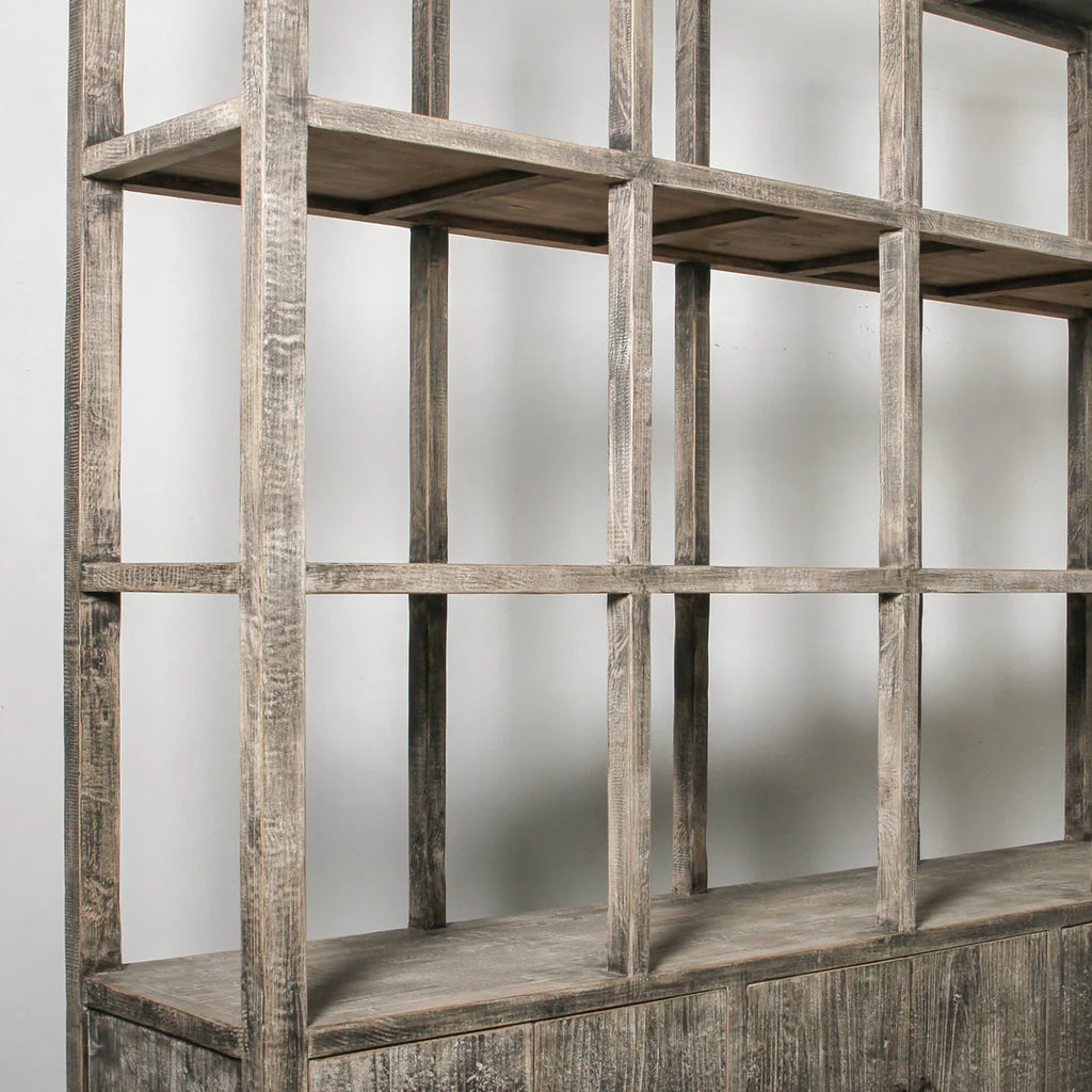 Wooden bookshelf with a grid design against a plain background