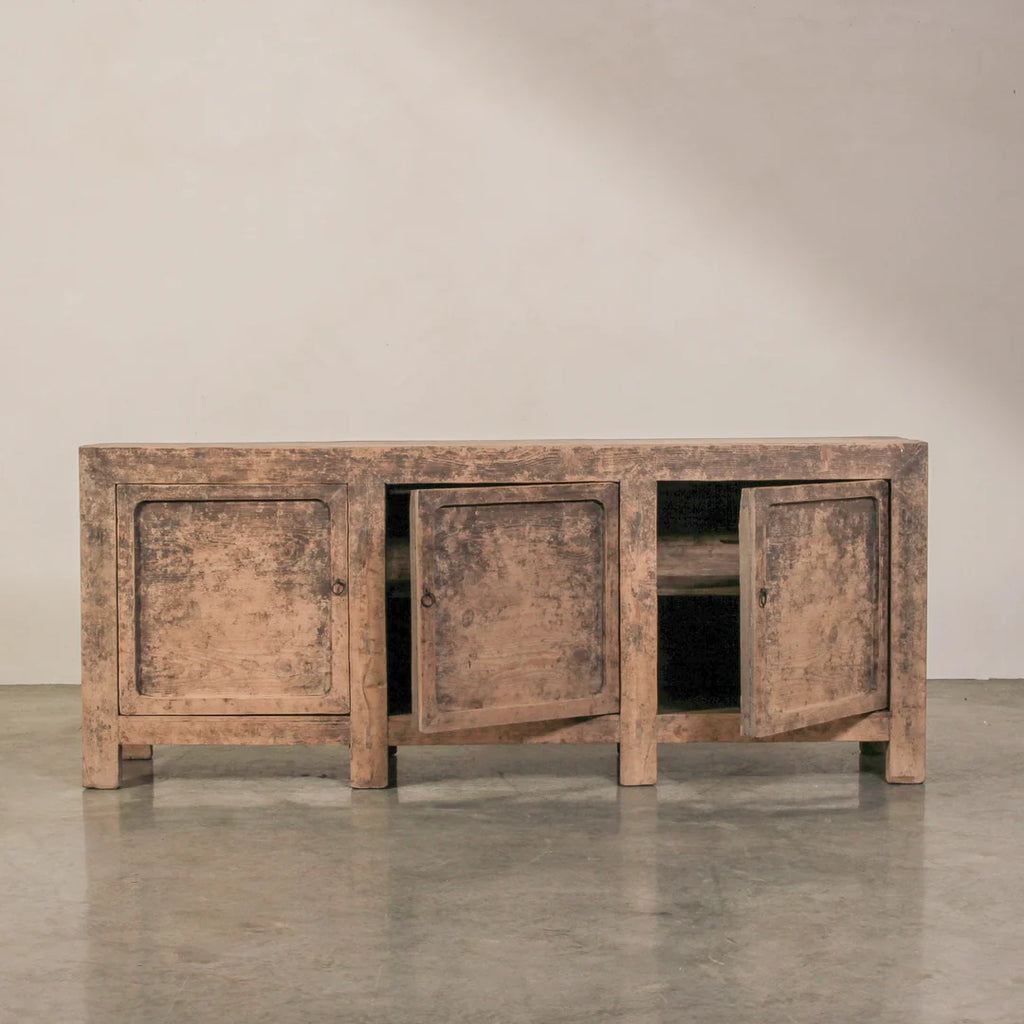 Wooden cabinet with three doors on a plain background