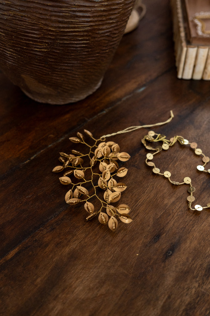 Gold Christmas decorations on a wooden surface with a rustic background