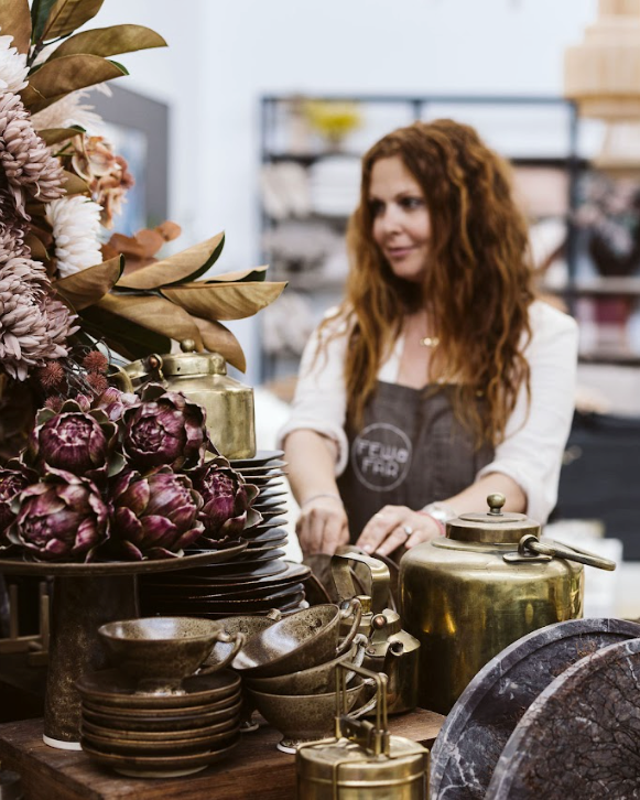 Woman in a store with decorative items and furniture
