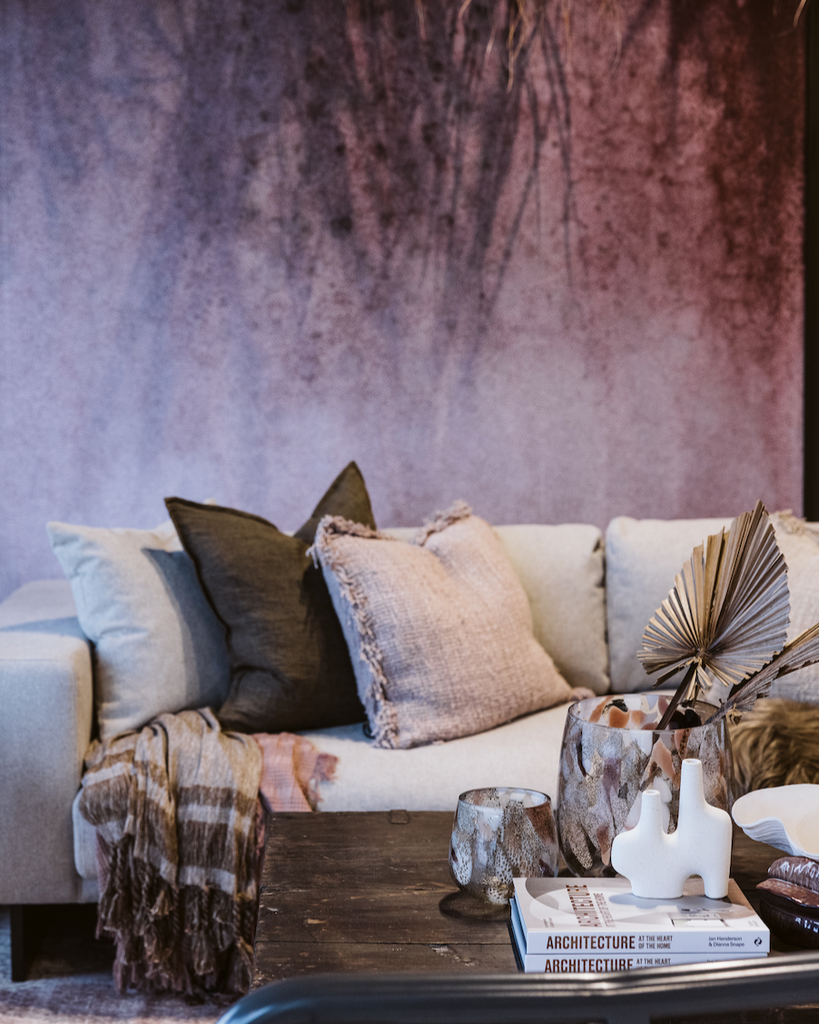 Cozy living room with a gray sofa, decorative pillows, and a wooden coffee table.