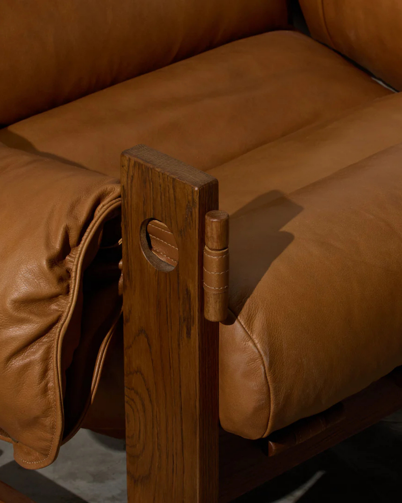 Brown leather sofa with wooden armrest support