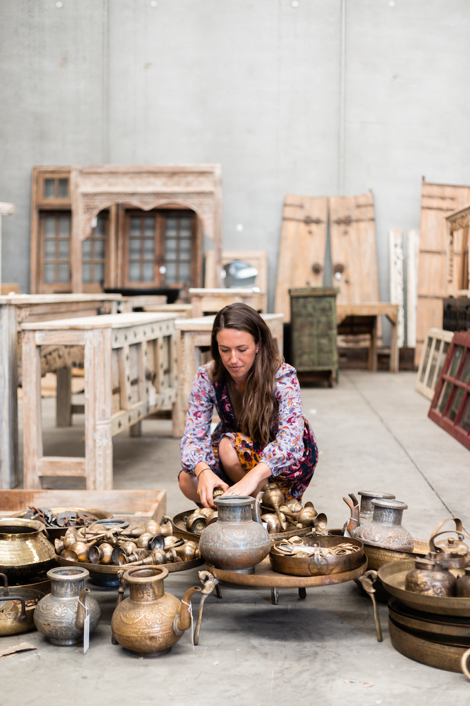 Woman arranging ceramic pots on a table in a workshop setting