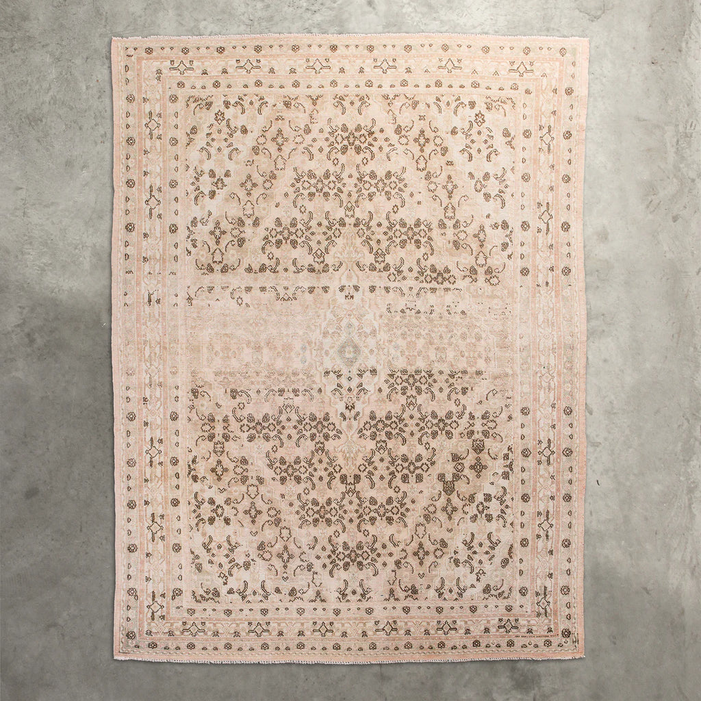 Decorative rug with intricate pattern on a concrete floor