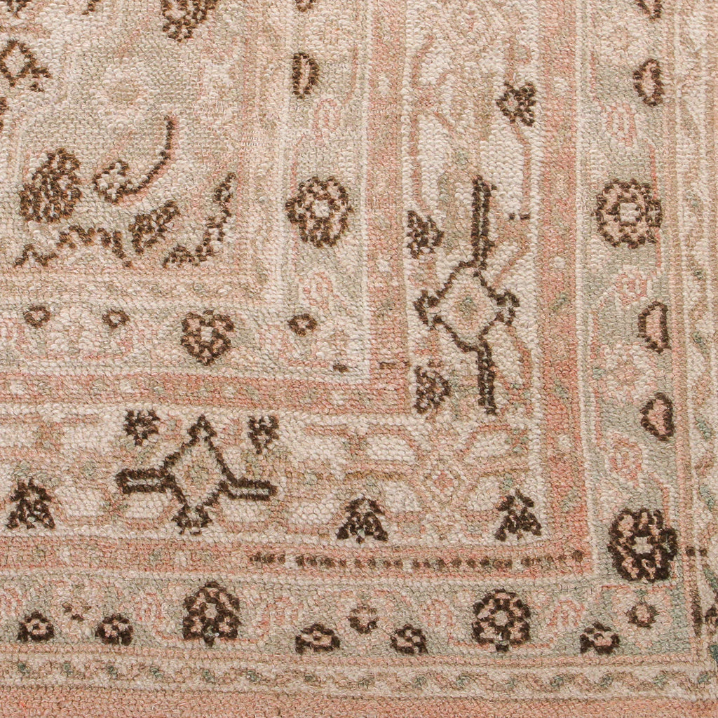 Close-up of a patterned rug with floral and geometric designs.