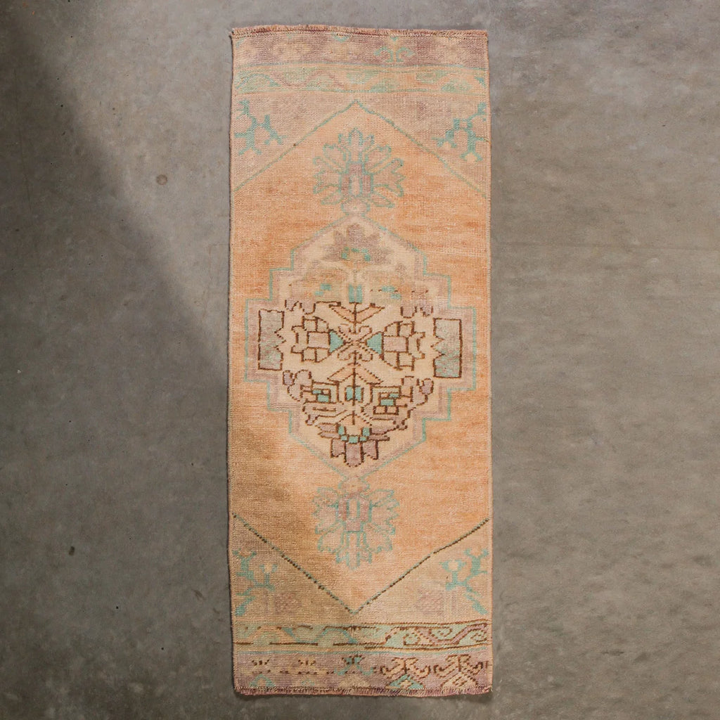 Decorative rug with geometric pattern on a concrete floor