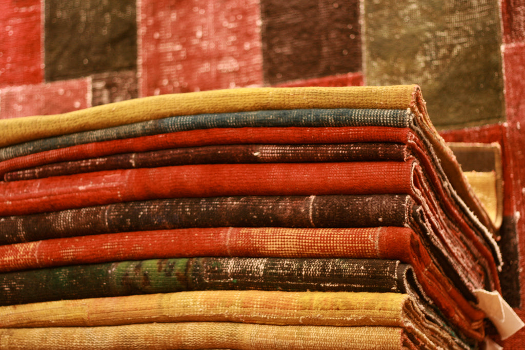 Stack of colourful turkish rugs with a blurred background