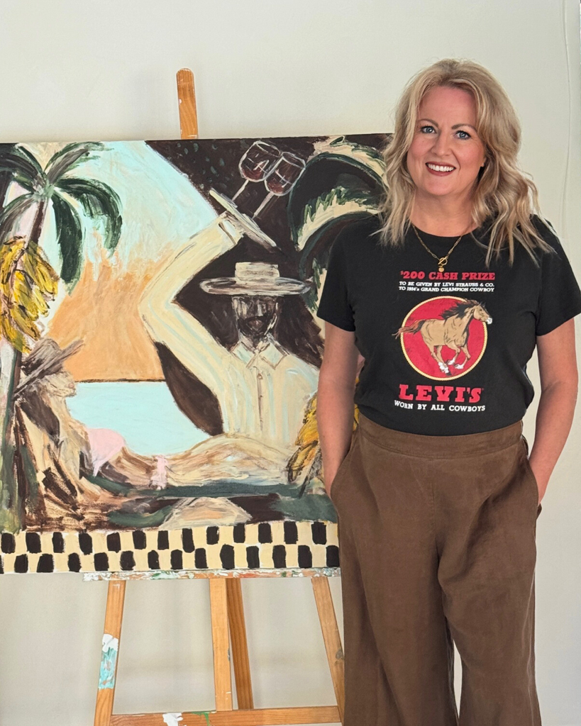 Yolanda Eke Artist standing in front of one of her abstract artworks